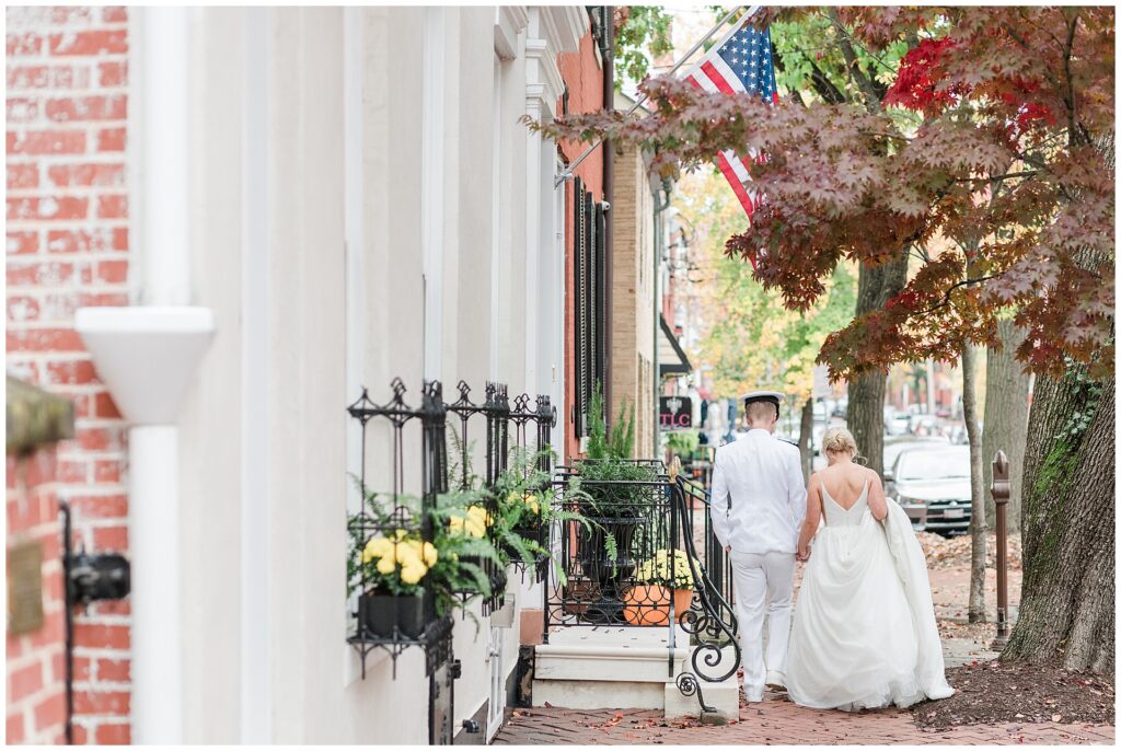 Naval officer and bride share intimate first look moment under fall foliage at historic Frederick venue, detail of bride's classic jewelry and gown