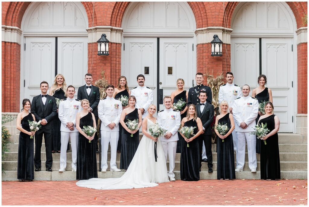 Classic wedding party portraits with naval officers in dress whites and bridesmaids in black gowns, historic brick church backdrop