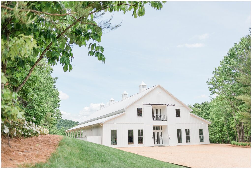 Ivy Rose Barn wedding venue in Virginia with white exterior and open sky backdrop