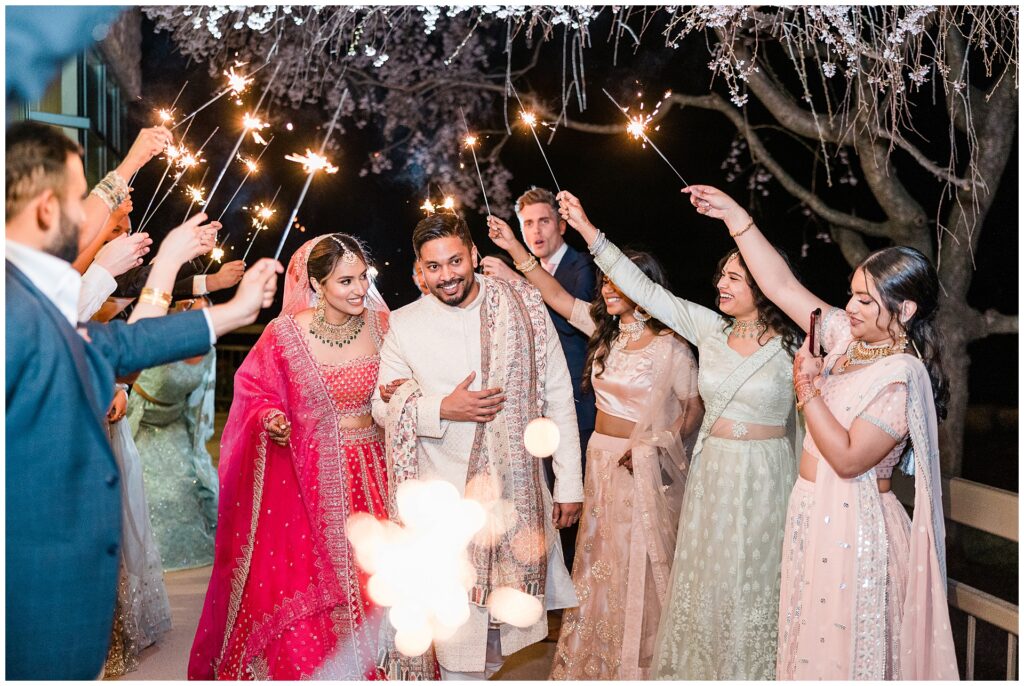 Indian wedding sparkler exit captured at night, highlighting full-day photography coverage during a Maryland wedding with extended reception timeline