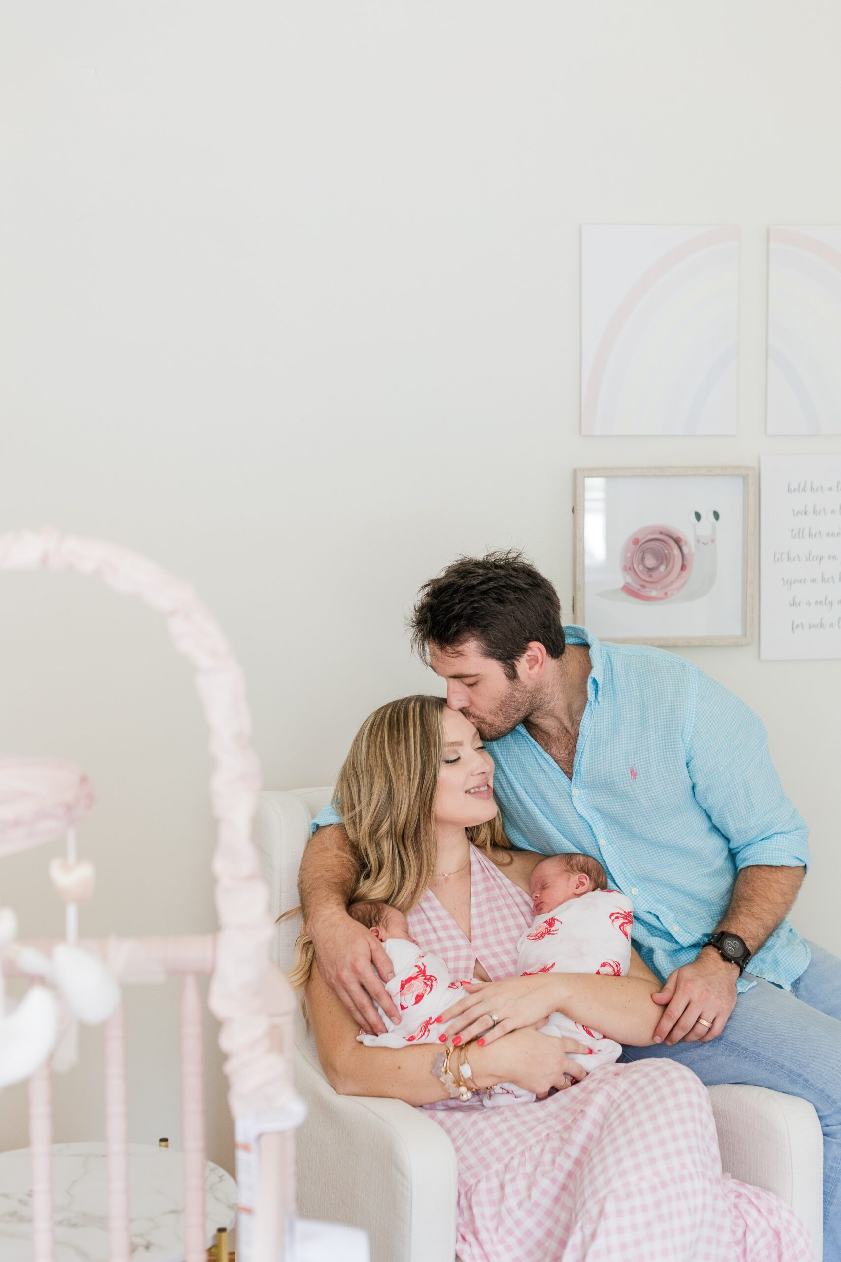 Newborn twin girls swaddled during an in-home session in Gaithersburg, Maryland, photographed by a Maryland newborn photographer.