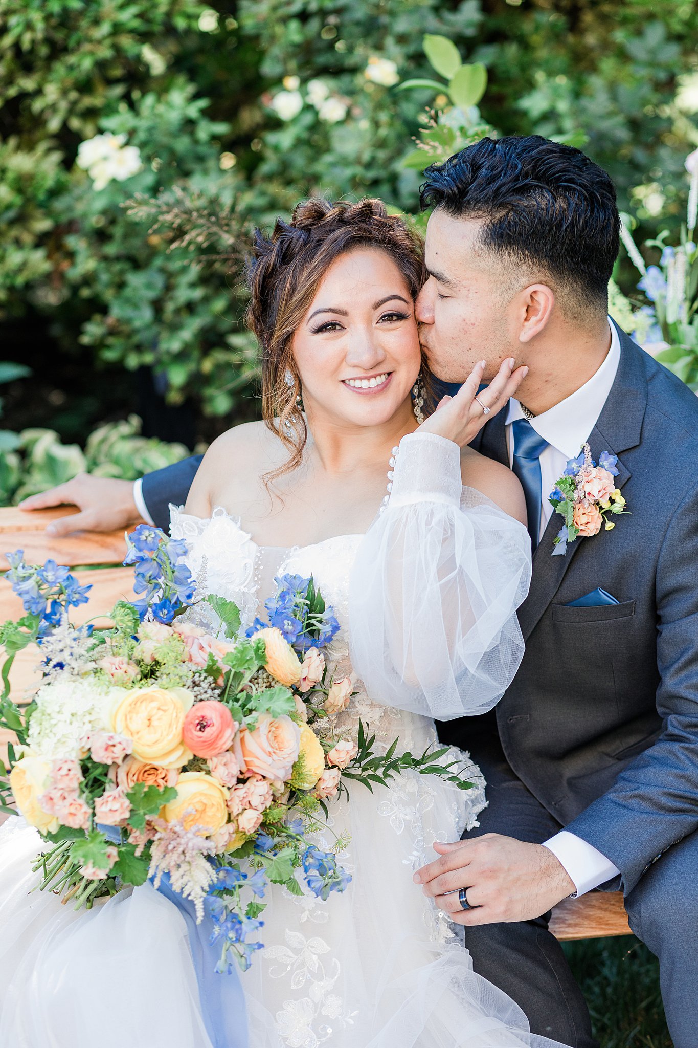 Close-up of joyful bride and groom at Cairnwood Estate with colorful bouquet, highlighting couple portraits captured during full wedding day timeline coverage