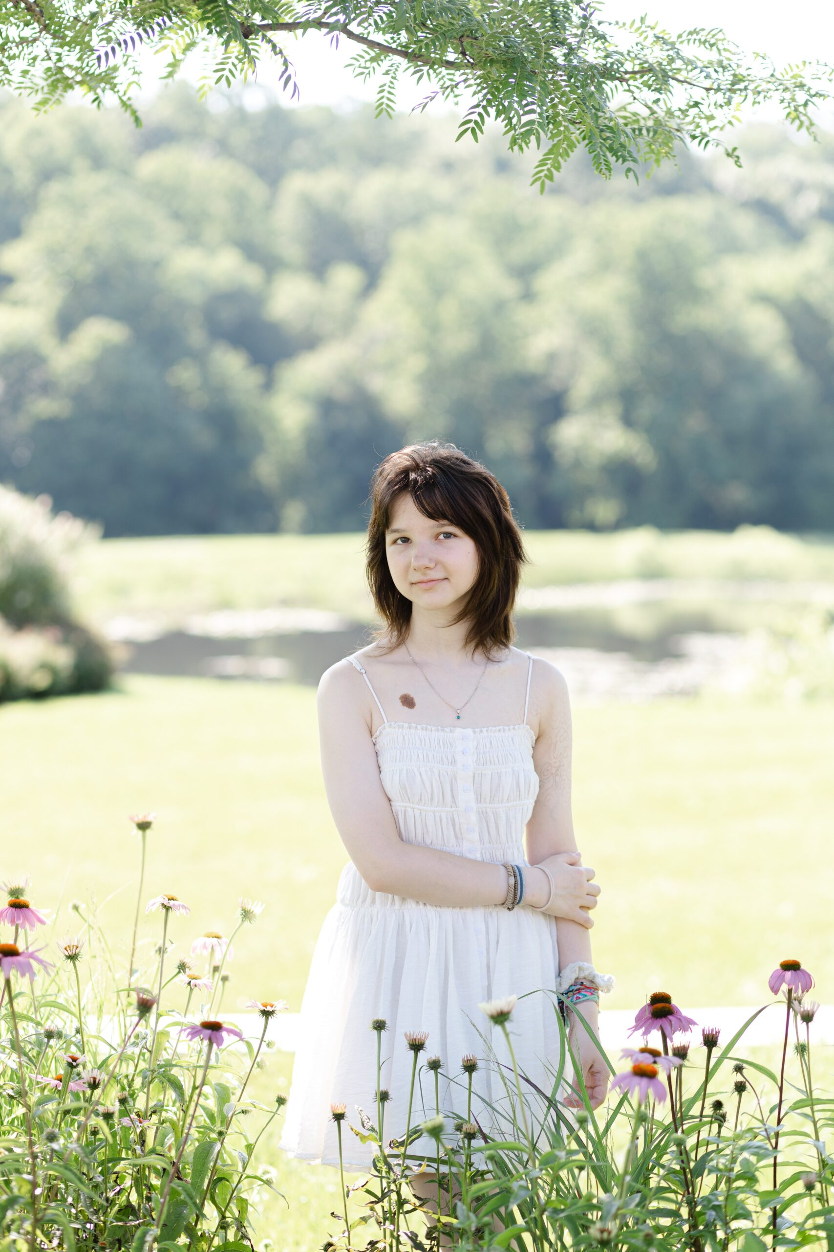 A senior from Atholton high school takes her senior photos in Maple Lawn, Fulton Maryland, surrounded by wildflowers