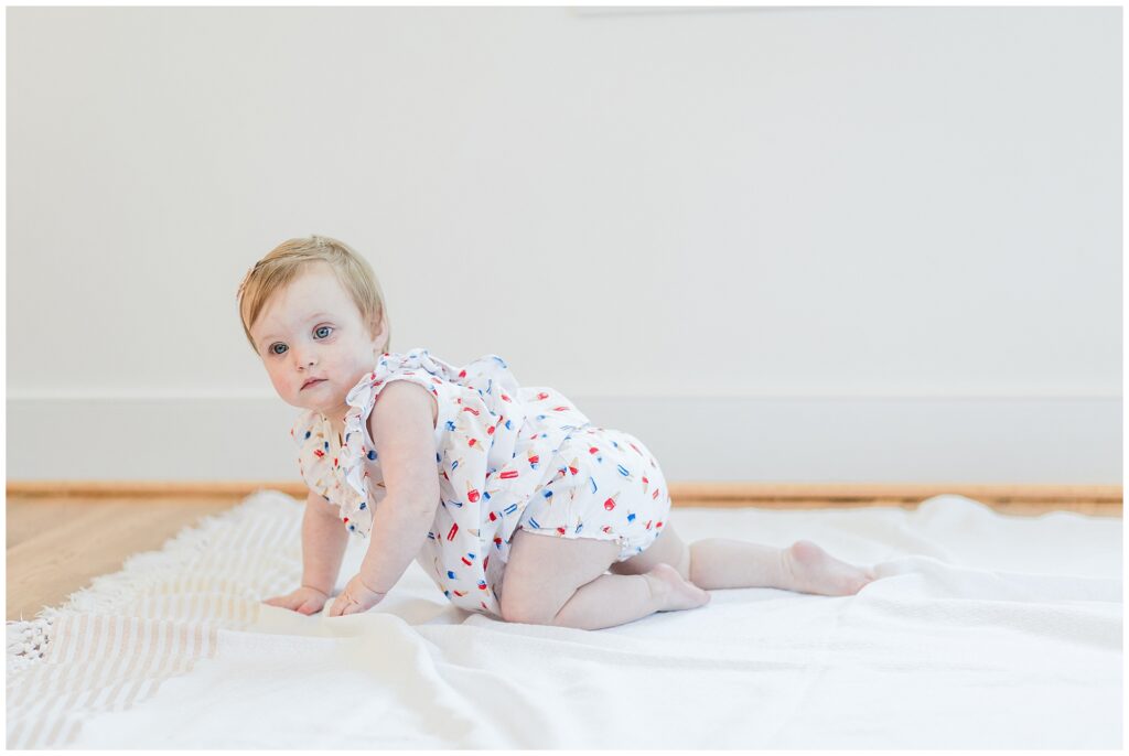 One-year-old crawling during a milestone family session in Montgomery County, Maryland.