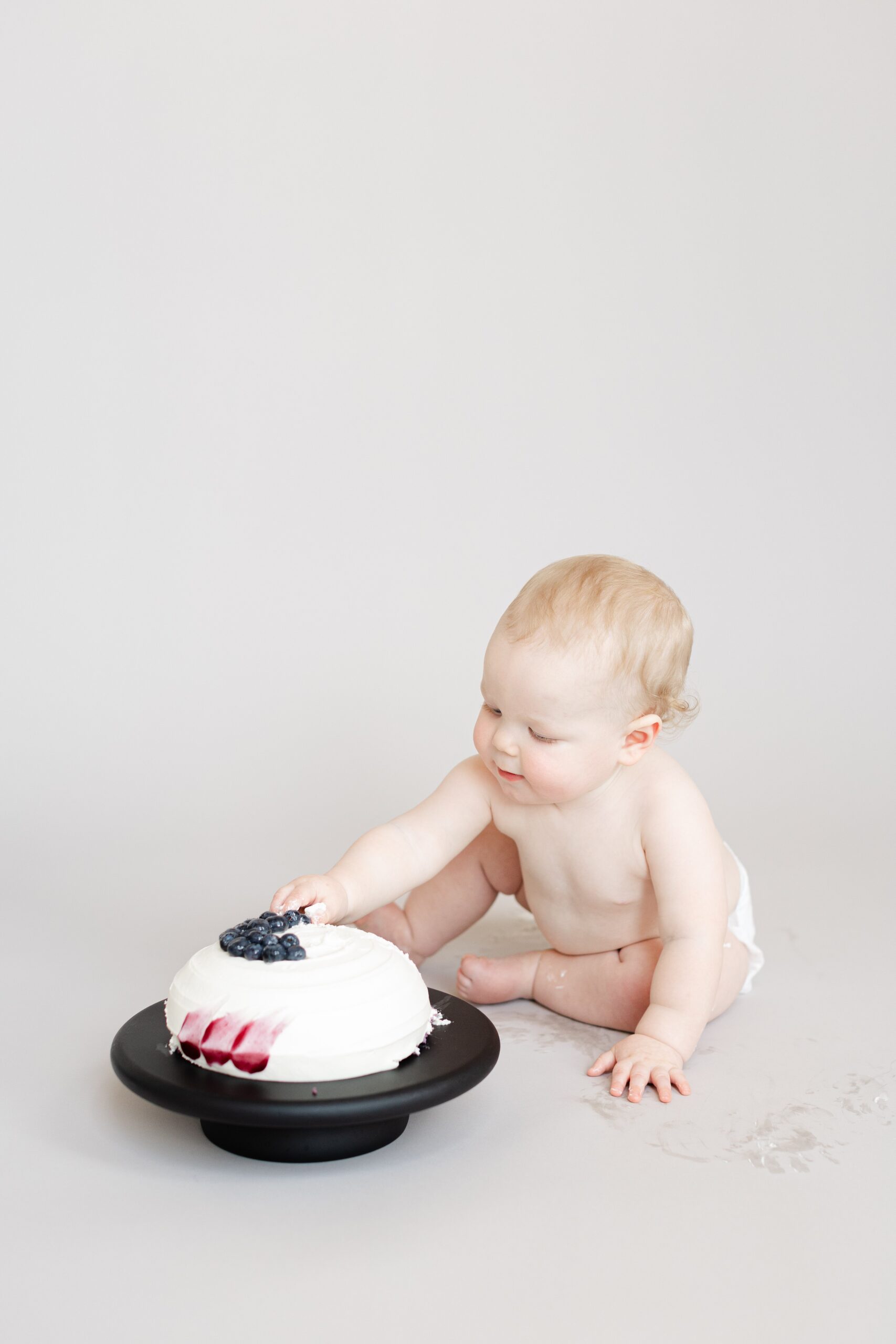 Howard County cake smash with clean, minimalist studio setup and joyful baby moments