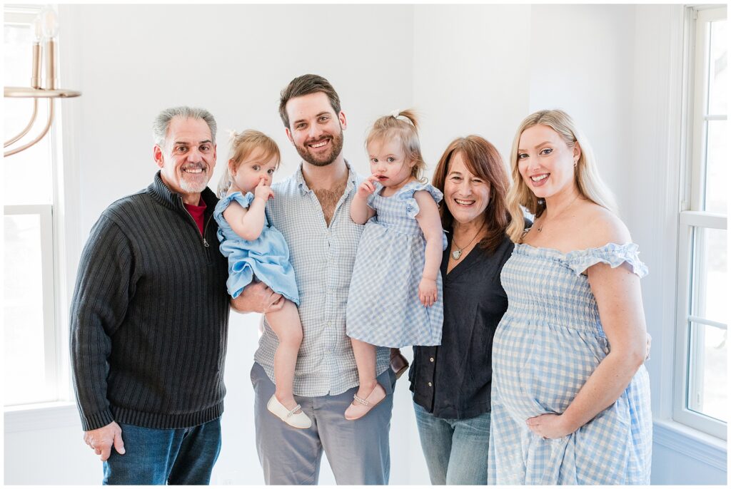 Parents and grandparents during maternity dress during an at-home photo session in Montgomery County, Maryland.