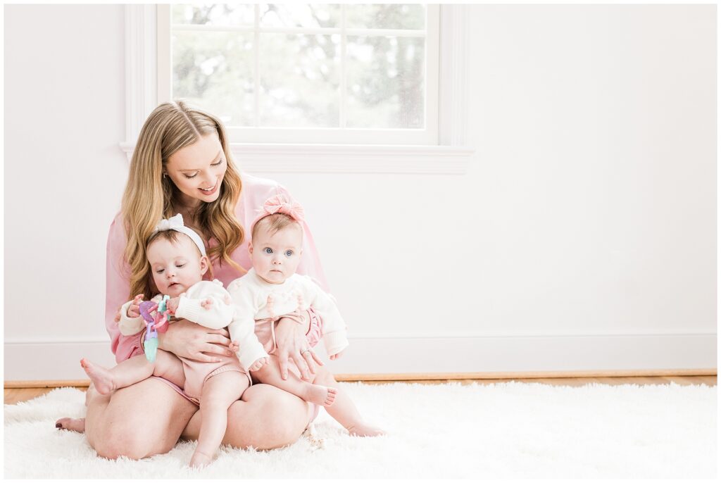 Mom with twin daughters during a six-month lifestyle family session at home in Gaithersburg, Maryland, by a Montgomery County family photographer.
