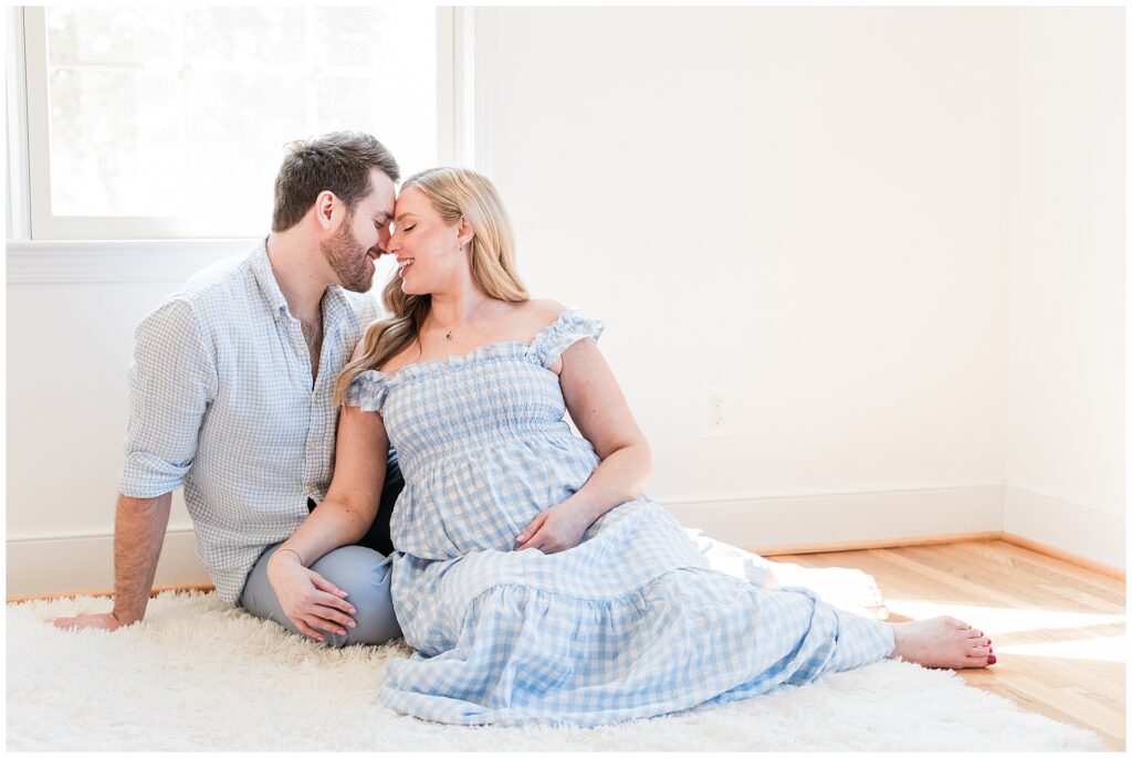 Mother-to-be in gingham dress during a styled maternity session at home