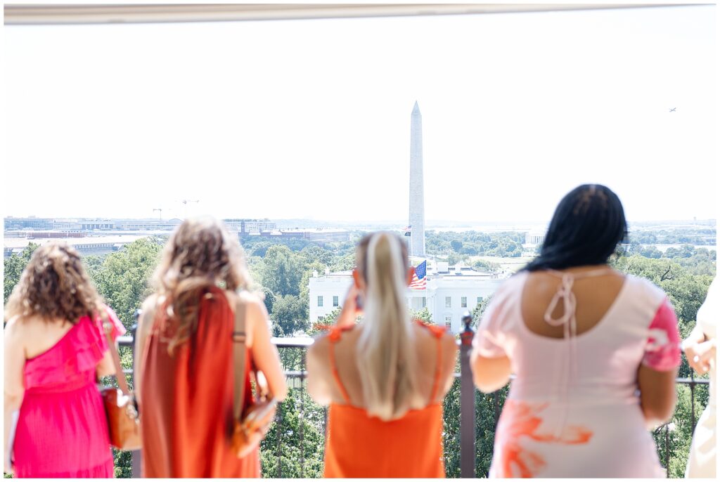 Wedding guests taking photos of the White House from the Top of the Hay rooftop at the Hay-Adams wedding venue in Washington DC