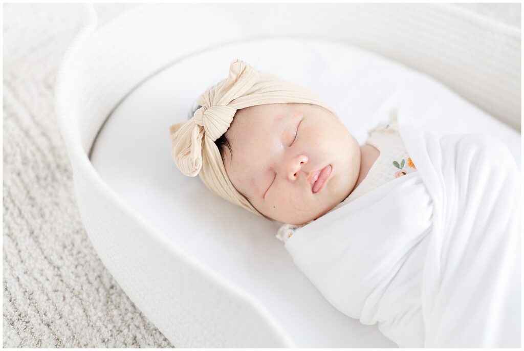 In-home newborn session in Ashburn Virginia featuring baby swaddled in a bassinet 