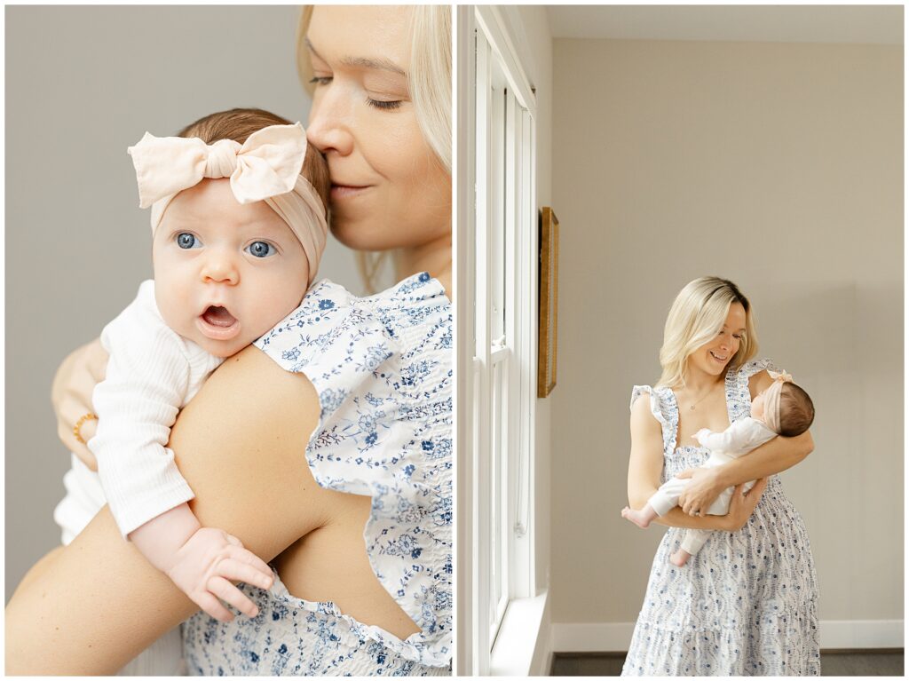 Mother in a white and blue floral dress holds her baby girl in their newborn home session
