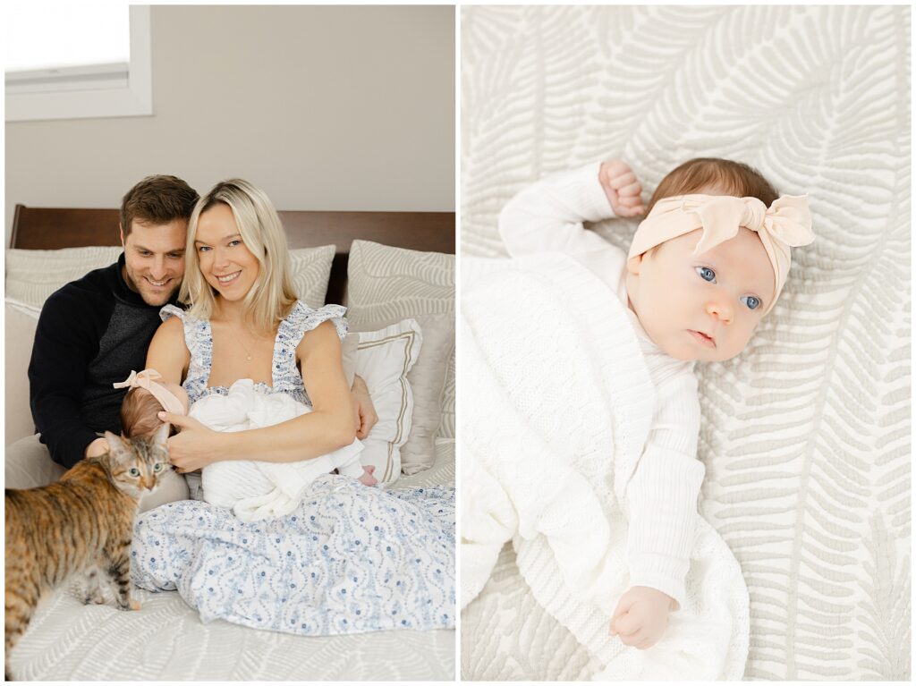 Mom in a white and blue floral dress  holds her baby girl in their newborn home session, in Virginia. Her husband cuddles with her on their bed with their cat in the foreground