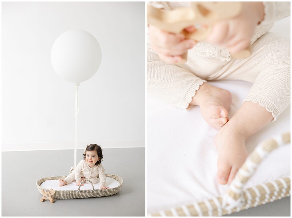 Full-body portrait of a one-year-old baby in a white bassinet with a wooden toy and white balloon during first birthday photos in Annapolis

Close-up detail of a baby’s feet in a soft oatmeal sweater during a first birthday studio session in Annapolis