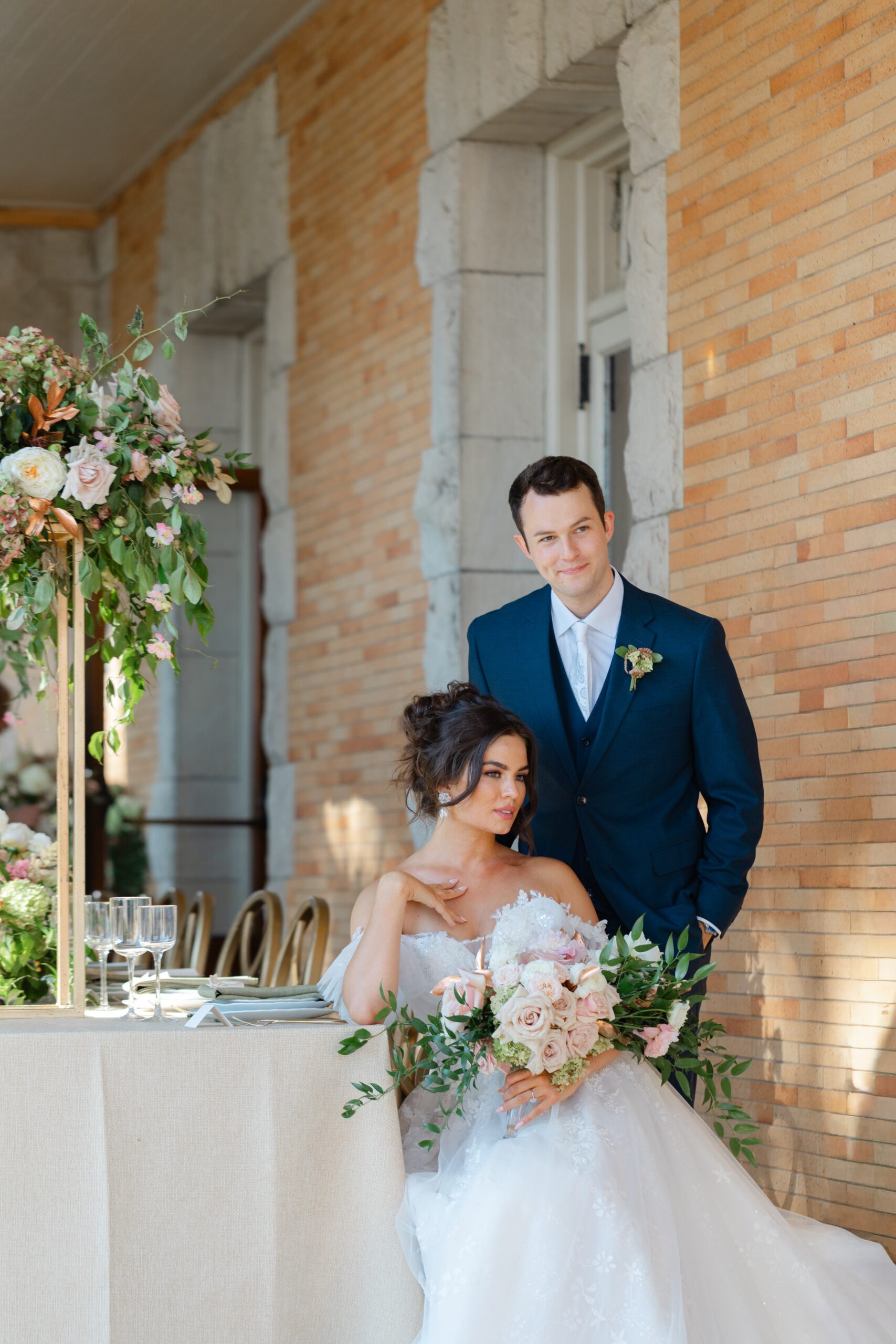 Bride and groom pose on the terrace of the Cairnwood Estate for their wedding in Pennsylvania, just outside of Philadelphia