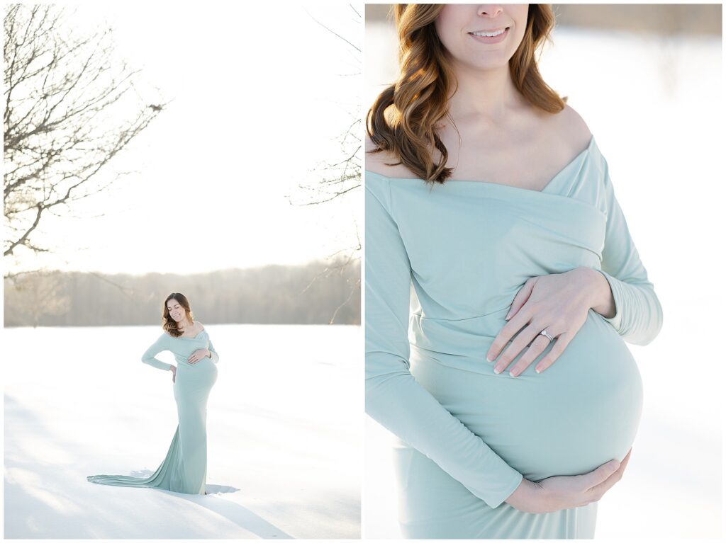 Pregnant woman in a green dress standing in the snow during her maternity session in Maryland